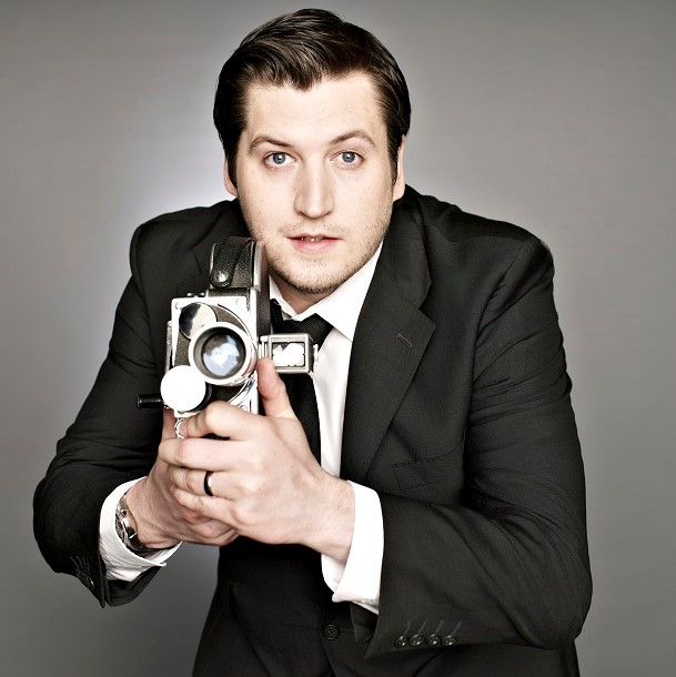 portrait of gareth evans holding an old film camera