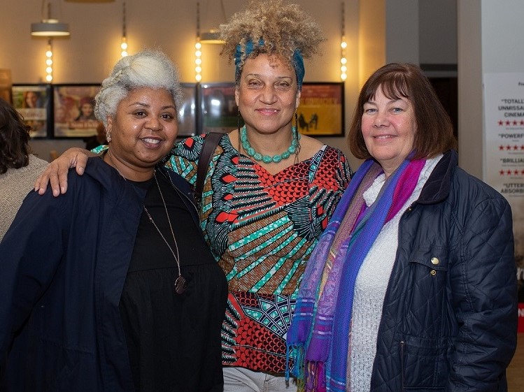 three people posing for a photo in the cinema foyer of chapter arts centre