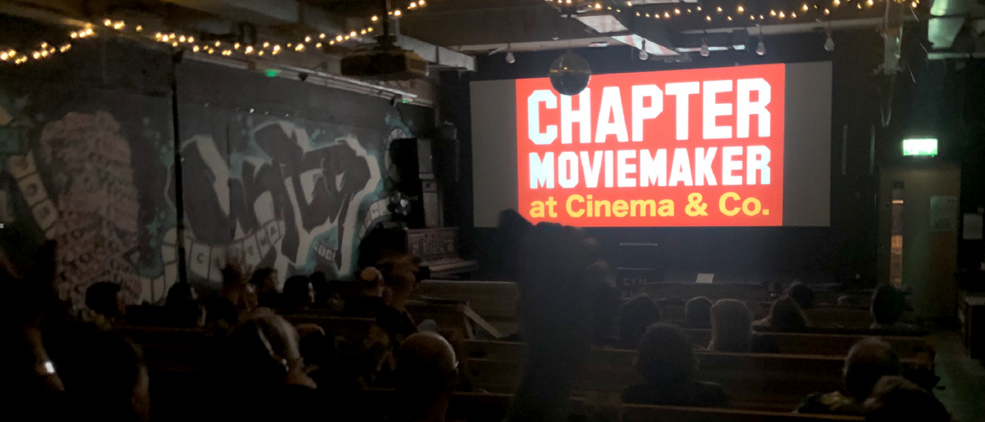 people sitting in a cinema with the chapter moviemaker logo on screen