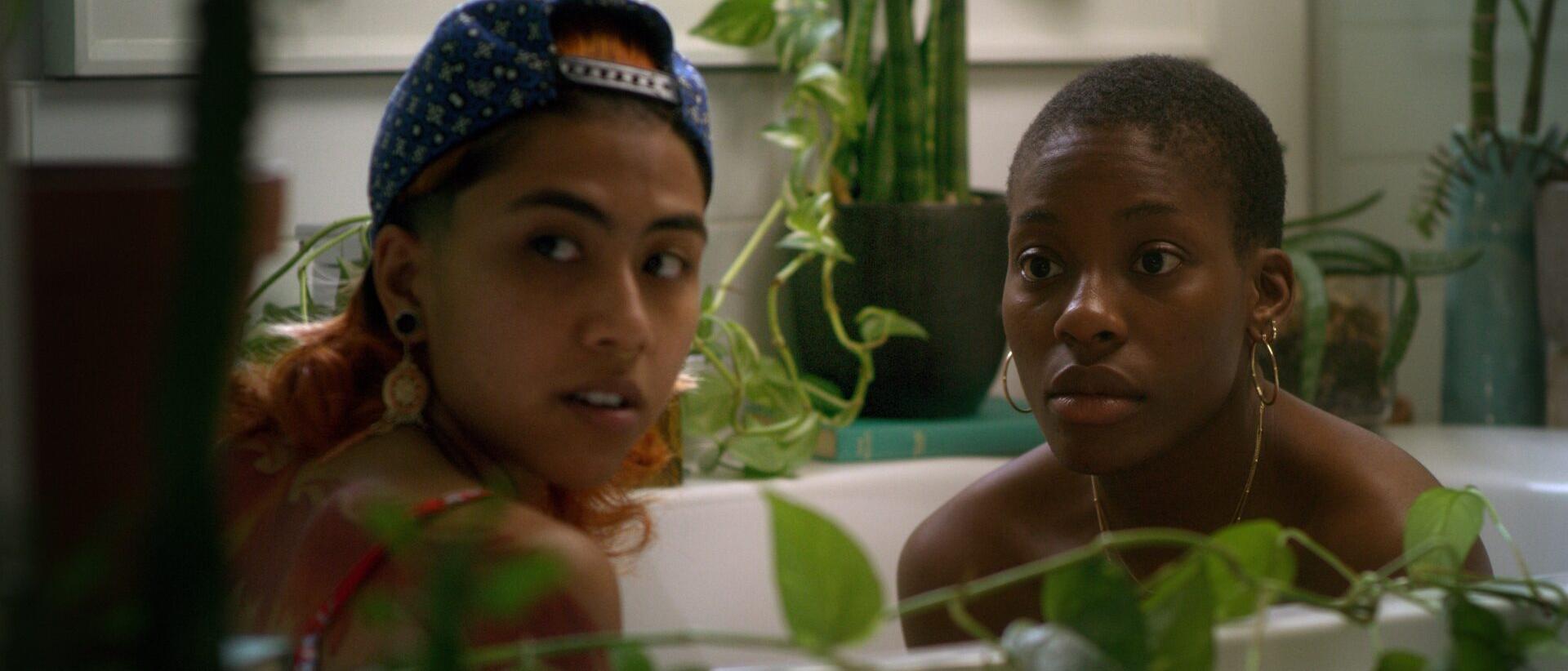 a still from Leyla & Noor, featuring two people sitting in a bathtub