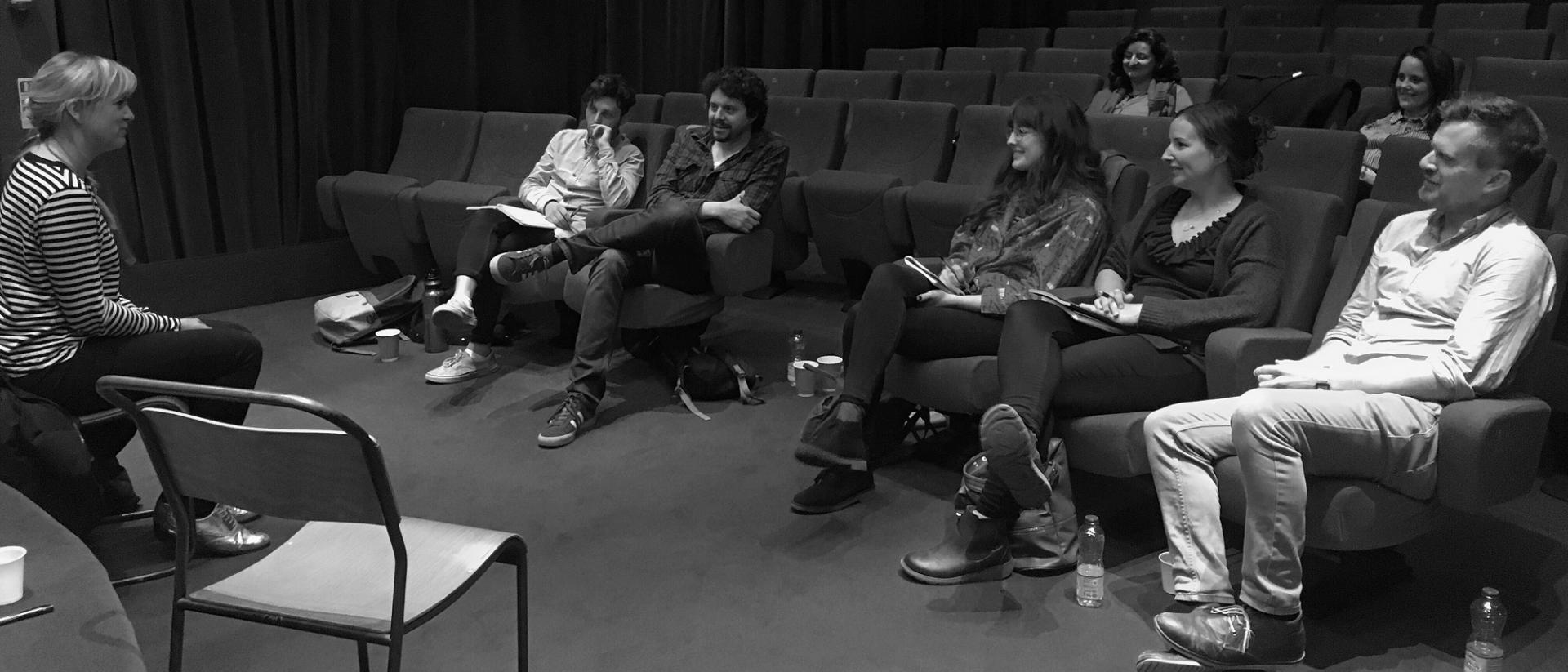 a black and white photo of people sitting in Chapter Arts Centre's cinema 2 listening to someone speak