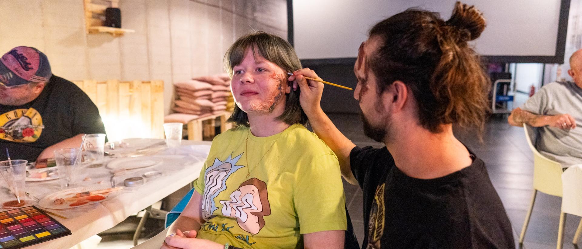people practicing theatrical make-up