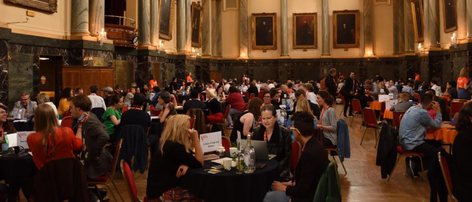 a hall with people networking at tables