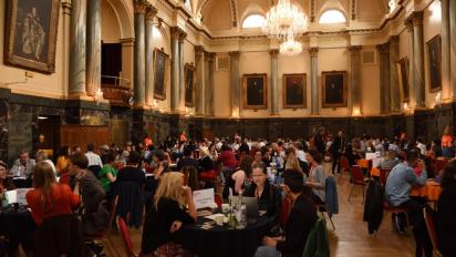 a hall with people networking at tables