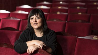 photo of nadia fall sitting in an empty theatre
