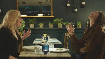 still from the almond and the seahorse featuring rebel wilson and charlotte gainsbourg sitting at a table in a restaurant talking and laughing