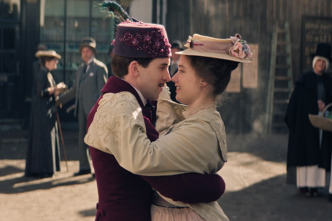 Still from Madfabulous fteauring Callum Scott Howells and Ruby Stokes dancing closely in the street. People in the background are watching them.