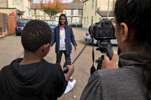 young people making a film in the street