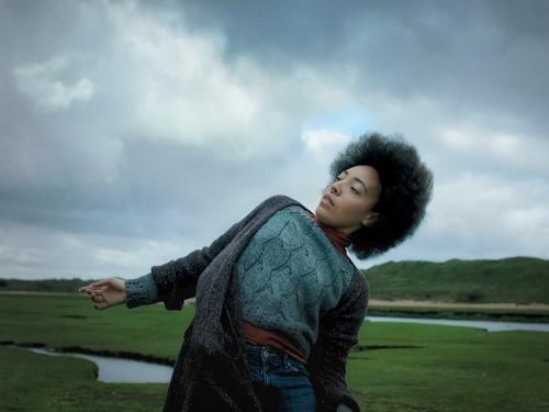 a person dancing on a flat green coastline