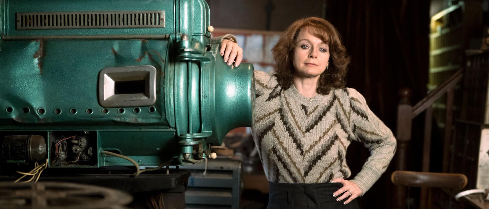 a still from save the cinema featuring samantha morton standing next to an old piece of machinery