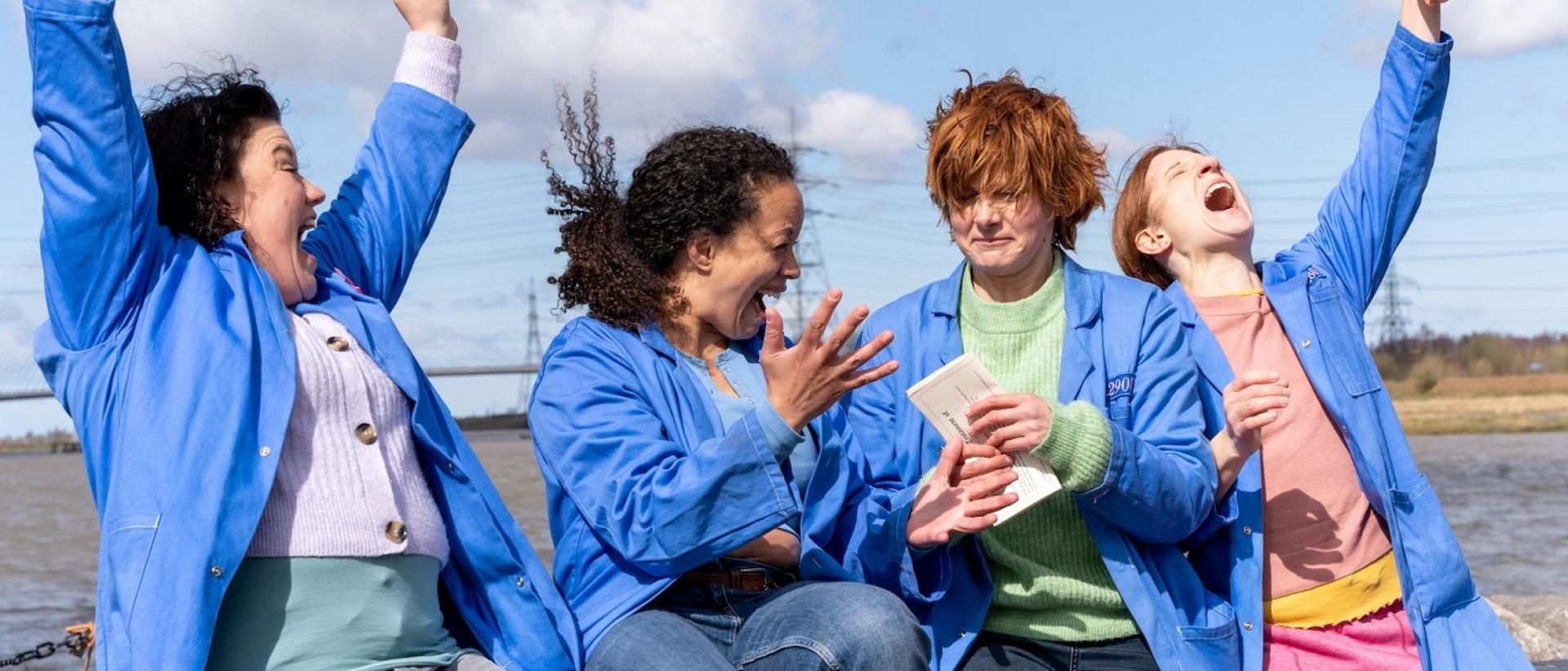 still from chuck chuck baby featuring four people sitting on a wall and celebrating