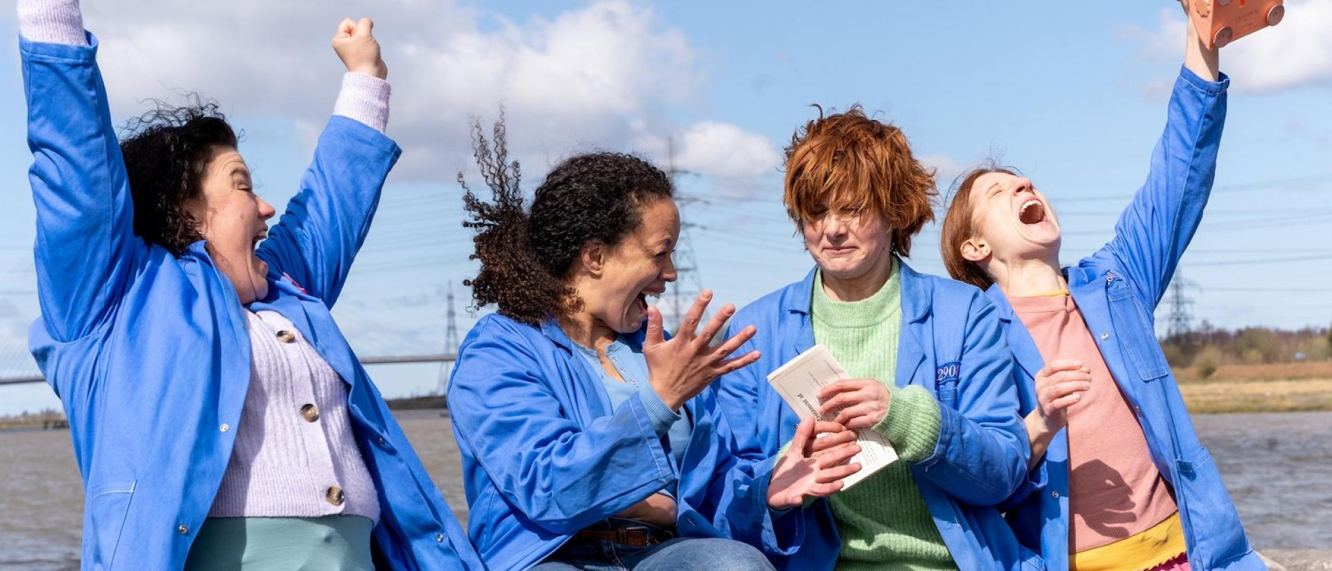 still from chuck chuck baby featuring four people sitting on a wall and celebrating