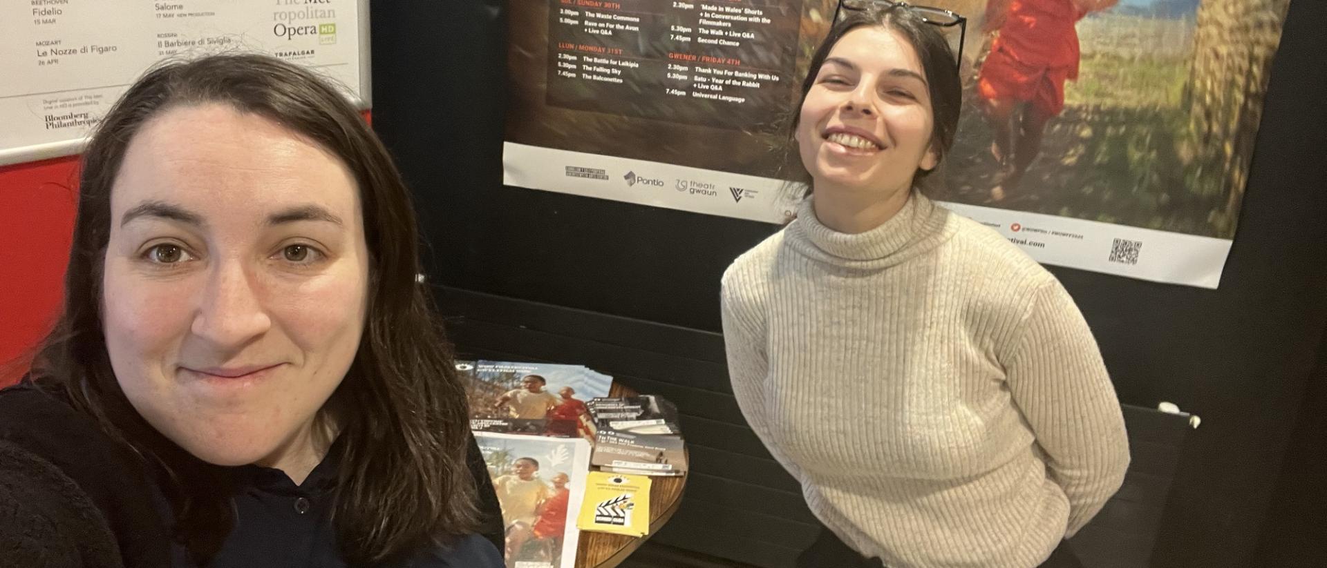 georgina and annita taking a selfie in front of a cinema poster for wow film festival