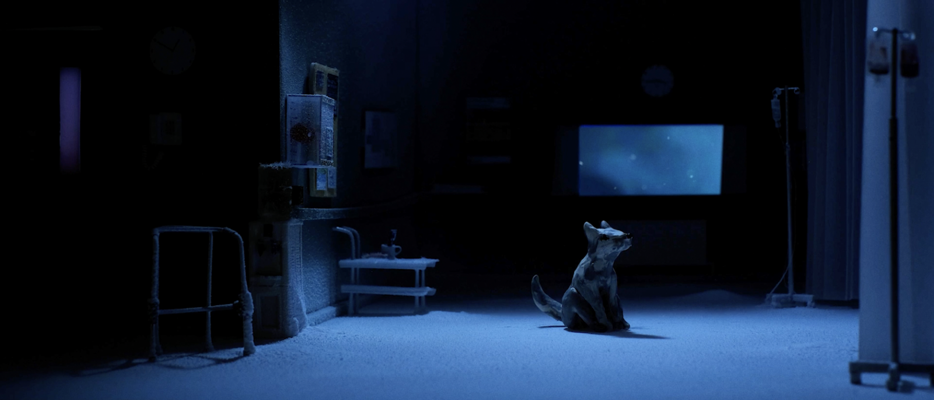 Still from short film Follow The Dogs featuring a stop-motion animation dog sitting in a dark hospital ward.