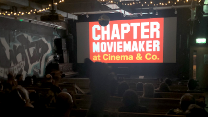 people sitting in a cinema with the chapter moviemaker logo on screen