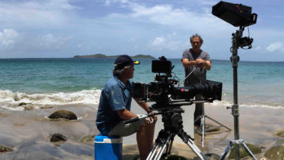 a photo of a film crew shooting on a beach