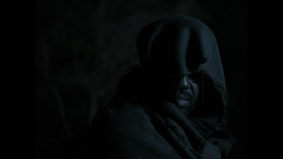 a still from Jackdaw featuring a man wearing a dark hooded cloak