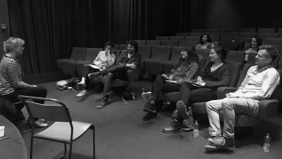a black and white photo of people sitting in Chapter Arts Centre's cinema 2 listening to someone speak