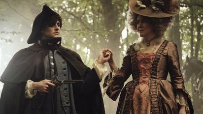 still from timestalker featuring two people in georgian costume standing in a wood holding hands. the person on the left is holding an old pistol.