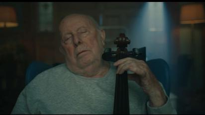 still from g flat featuring an elderly man playing the cello