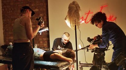 photo of a documentary film crew filming a person getting a tattoo