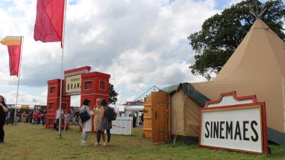 photo of the sinemaes tent at the eisteddfod, featuring a red and white sign that reads "Sinemaes"